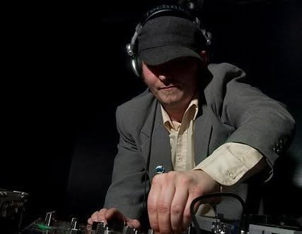 Unkle Funk in the booth, hat and blazer